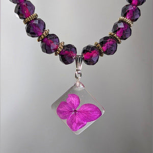 Royal Depth: Purple glass bead necklace with diamond shaped flower pendant - Nature's Lure