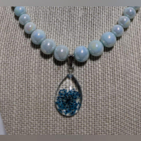 Smooth Royalty: Faint blue glass pearl necklace with teardrop shaped flower pendant - Nature's Lure